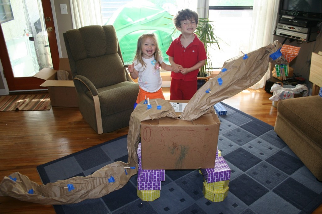 A Diplodicus built with cardboard blocks, cardboard box, brown paper, and broom sticks!
